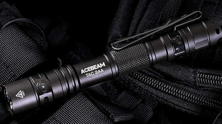 ACEBEAM TAC EDC 2AA Flashlight resting on bag