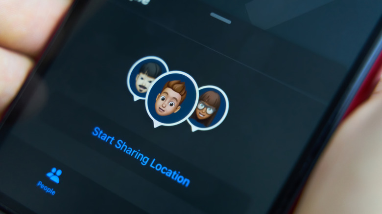 Close-up of an iPhone with Find My showing sharing location.