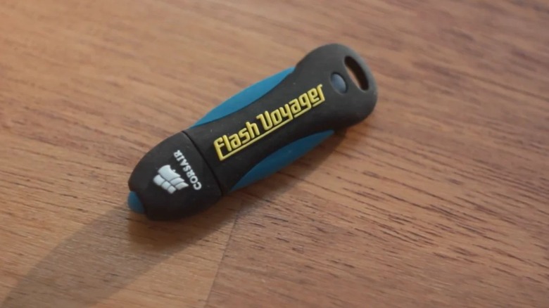 A Corsair Flash Voyager drive on wooden surface