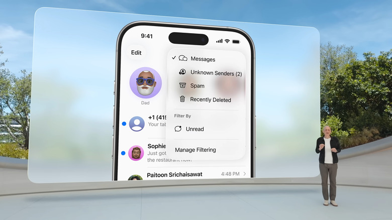 Man with large screen behind showing iPhone Messages new folders feature in iOS 26