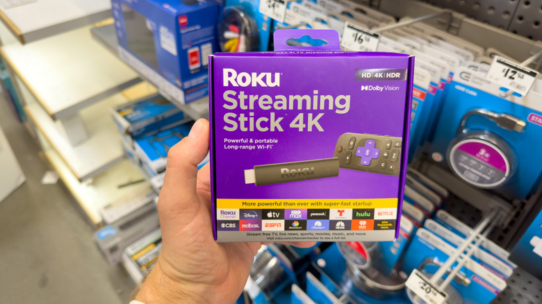 A person holding the Roku Streaming Stick 4K.