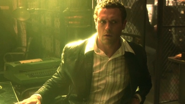Jason O'Mara as Sam Tyler in Life on Mars sat at a desk