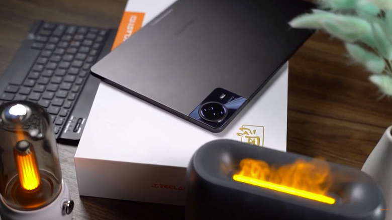 a Teclast tablet sitting atop its box with some lights by it
