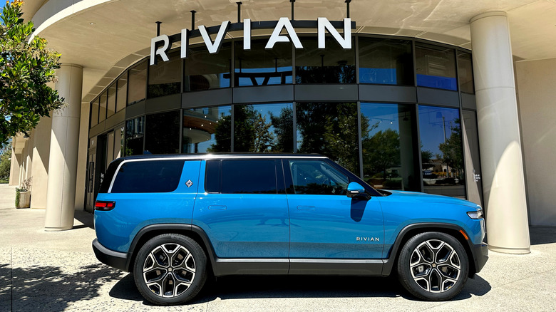 an electric vehicle, a blue Rivian, outside a Rivian dealership