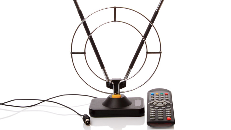 TV antenna and remote control on white background