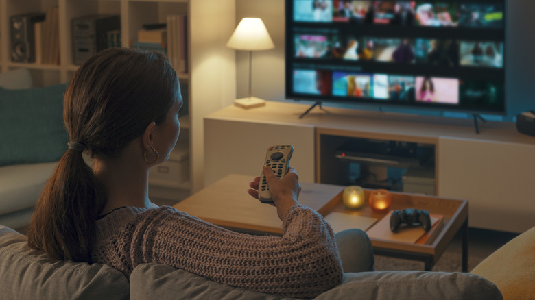 Woman watching TV in her living room