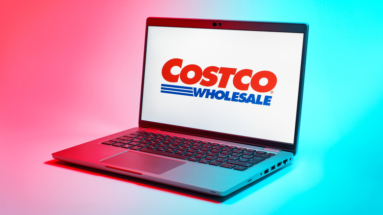 A laptop displaying the Costco Wholesale logo, the image itself has a red and blue effect that splits the colors down the middle of the image