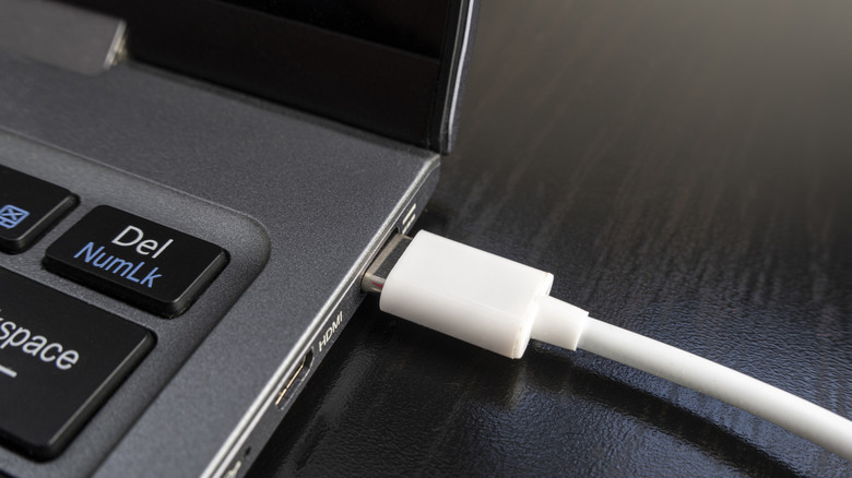 A plugged-in laptop, closeup shot.