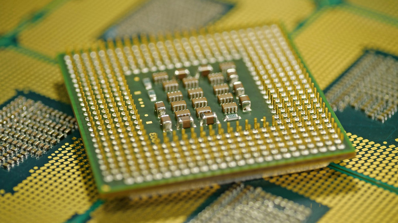 An exposed CPU chip laid atop other CPU chips.