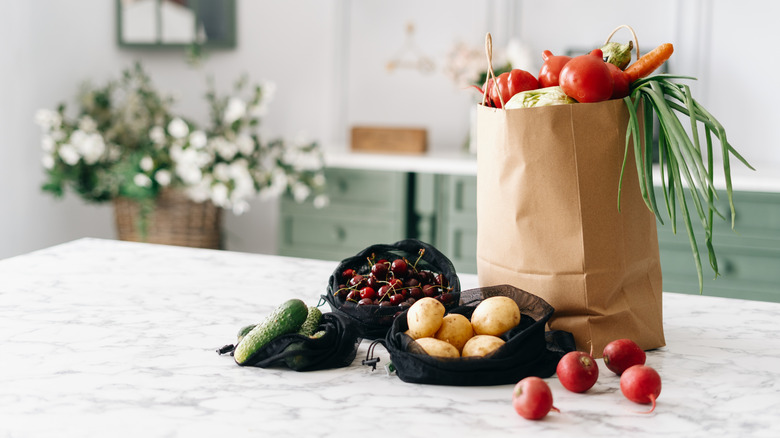 Bags of groceries on a kitchen counter.