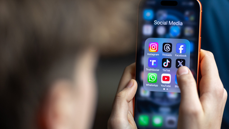 Person looking at smartphone apps on smartphone