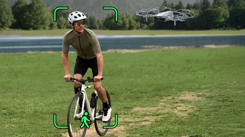 The Potensic Atom 3 flying near a person on a bicycle and detecting the rider with AI Tracking 2.0 mode.