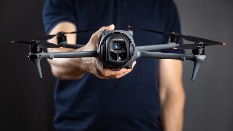 DJI Mavik 4 Pro drone held in user's hands.