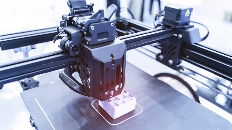 3D printer printing a white box