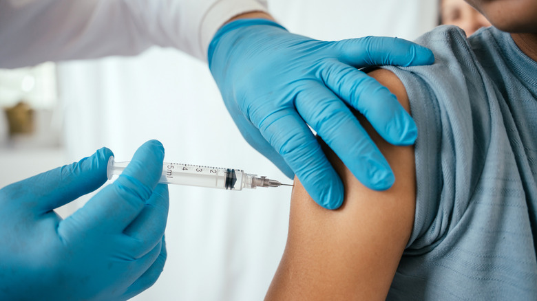 Doctor administering vaccine to patient