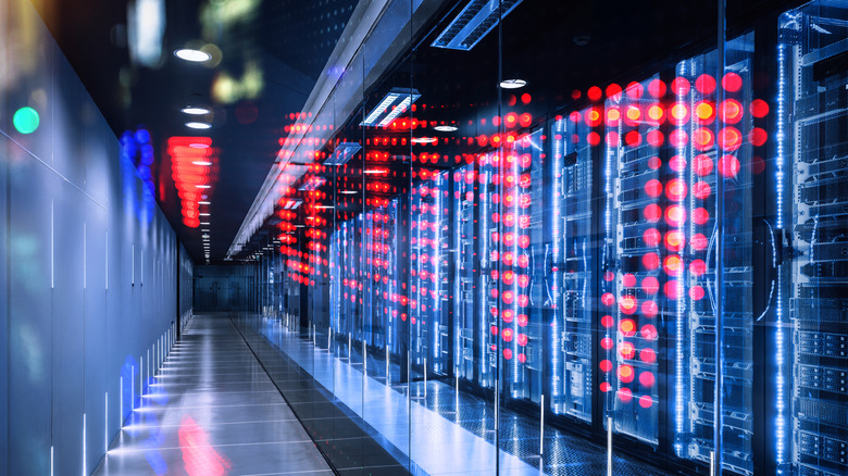 Server racks in a data center with red LEDS illuminating the foreground.