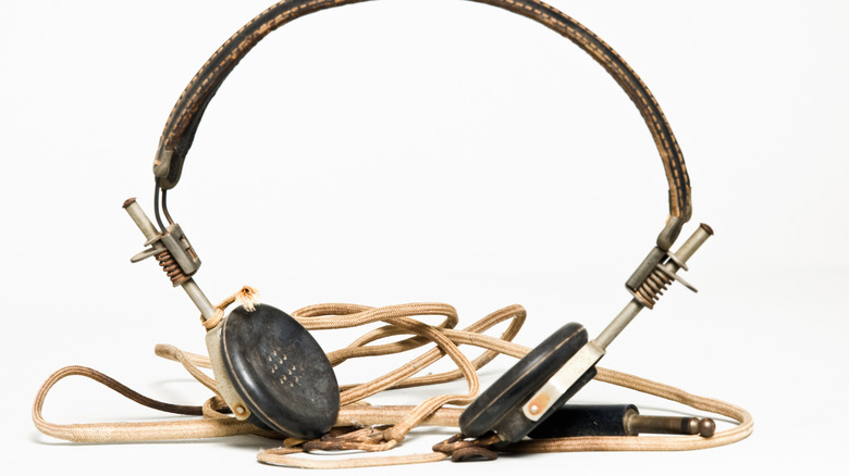 Antique pair of headphones on a white background.