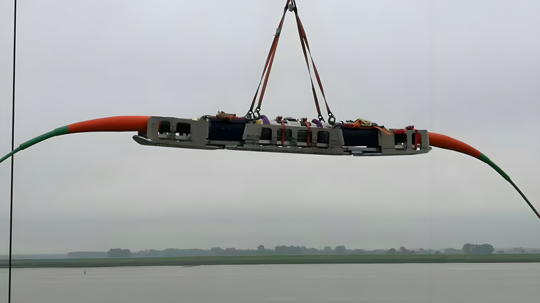 Submarine cable and repeaters being loaded onto a freighter