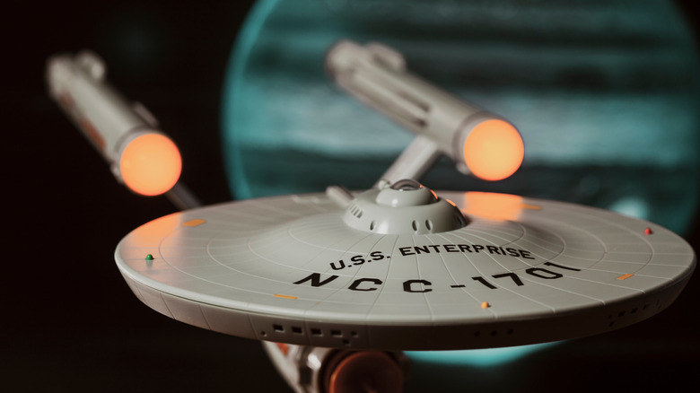 A close-up shot of a plastic model of the starship Enterprise