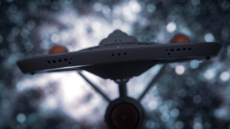 A front view of the USS Enterprise, its nacelles visible behind its saucer section.