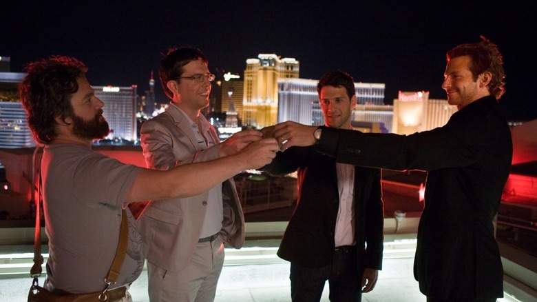 Justin Bartha, Bradley Cooper, Zach Galifianakis, and Ed Helms raising a glass in The Hangover