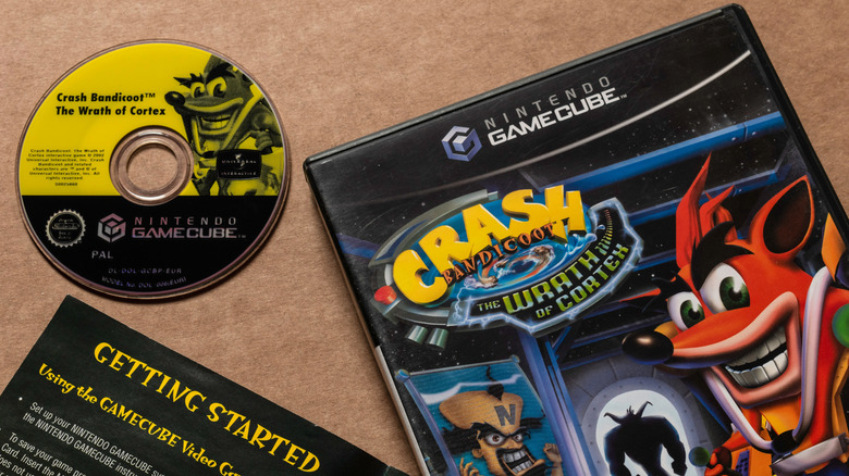 Crash Bandicoot GameCube disc next to case on brown table