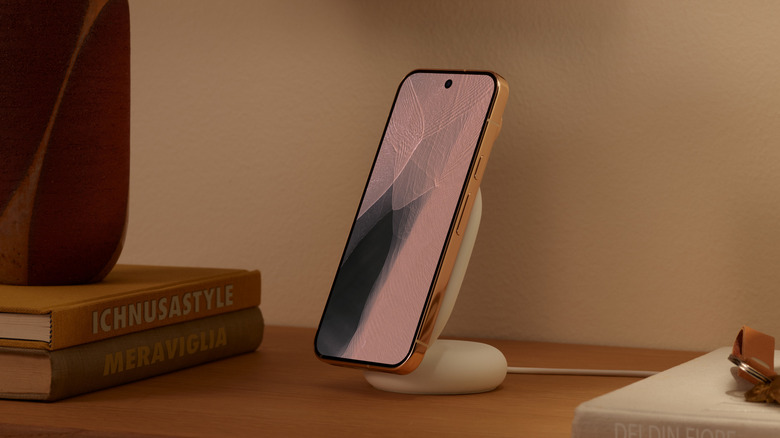 Close-up of the Pixel 11 Pro in new orange color on the Pixelsnap charger