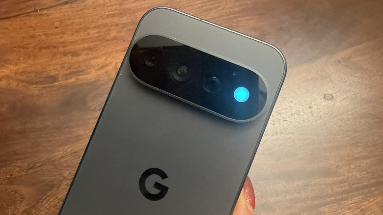 A Google Pixel 11 Pro in hand with the HiLight shining blue.