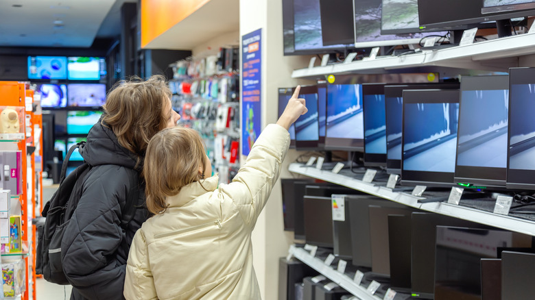 Two people shopping for a new TV.