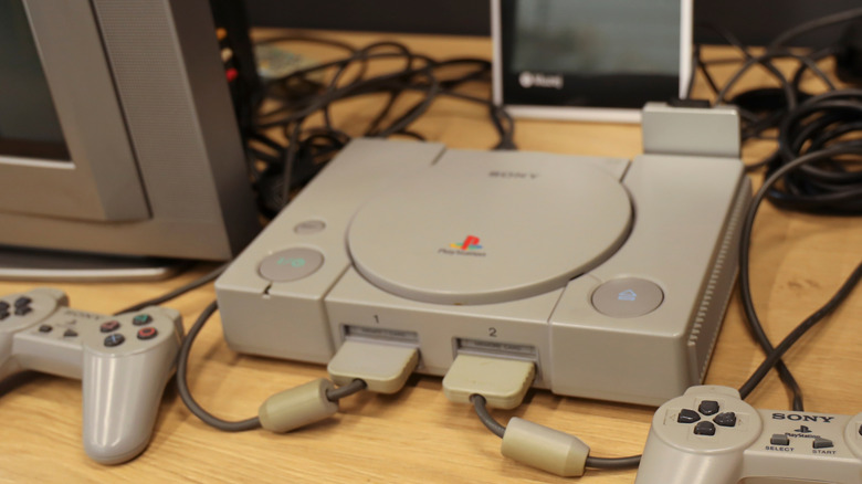 A retro PlayStation console plugged into a modern TV