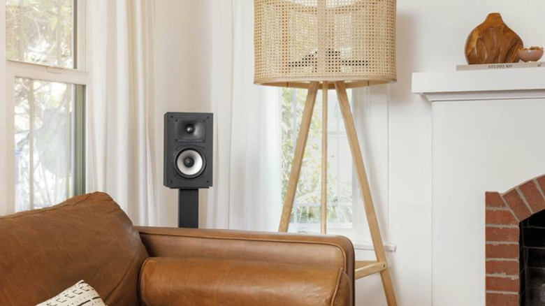 A single Polk Audio Monitor XT15 set up on a speaker stand in a living room.