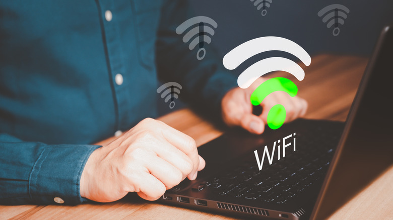 Man on laptop connecting to wifi