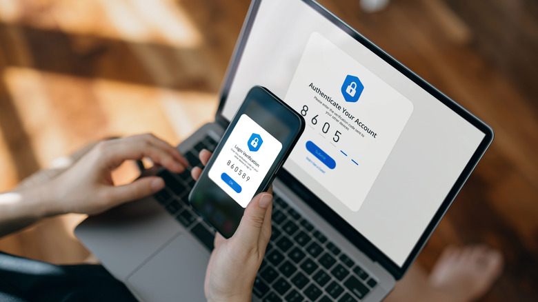 A person using two-factor authentication with a laptop and smartphone to sign into an account.