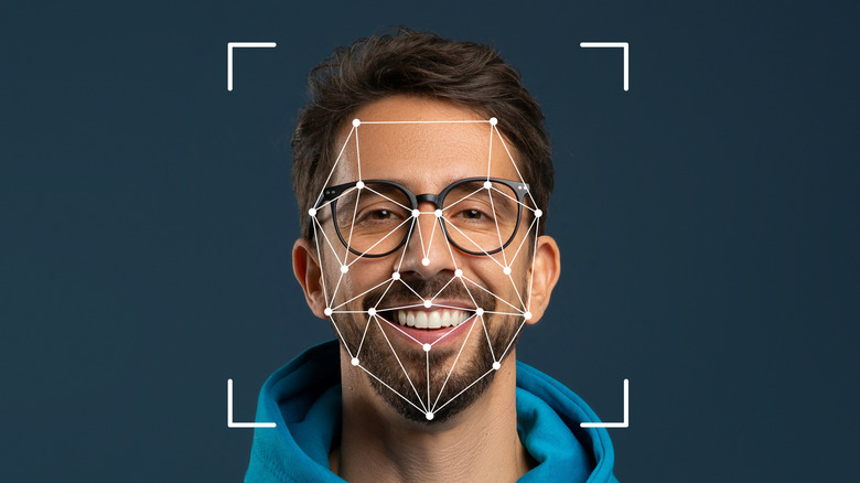 A smiling man being scanned by facial recognition technology.
