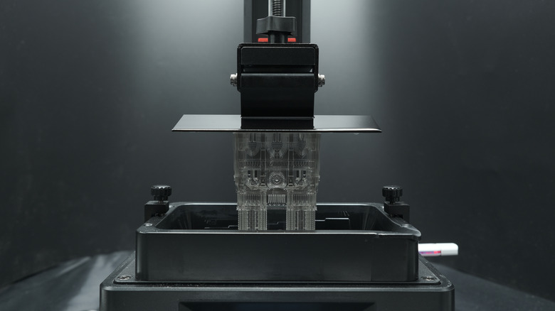 Inverted stereolithography 3D printer lifting resin part out of tank