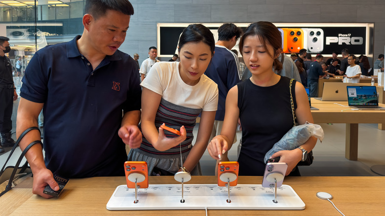 Consumers looking at the new iPhone 17 Pro models in an Apple store.