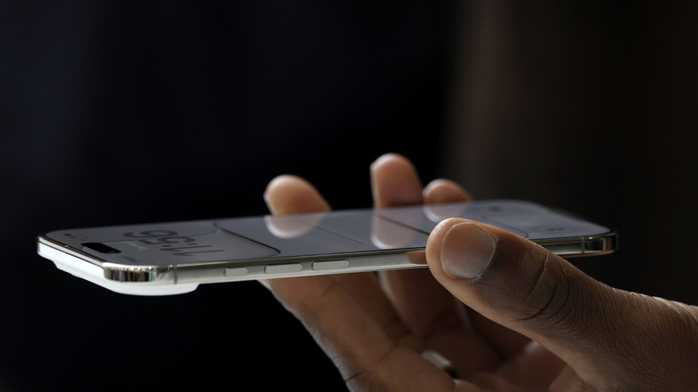A person holding an iPhone Air