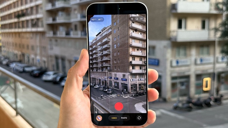 A hand holding an iPhone 17 Pro with the Camera app opened