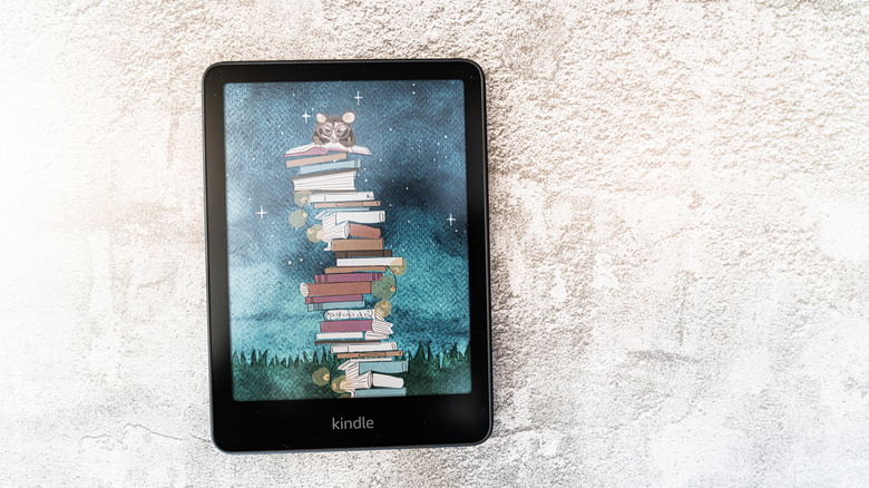 kindle colorsoft with colored background showing books in the sky