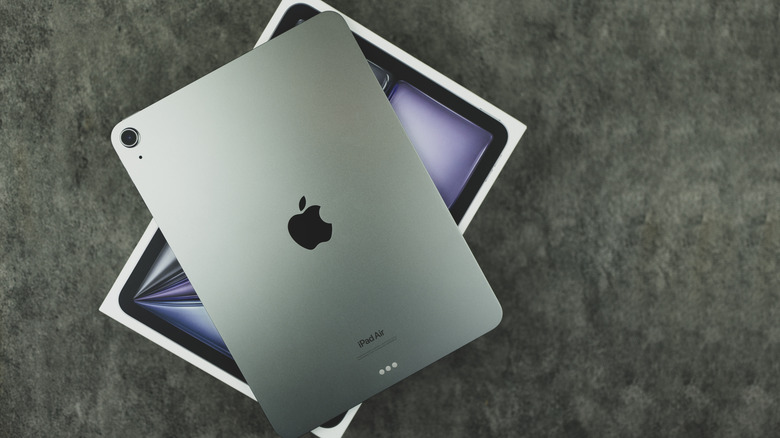 An iPad sitting on top of an iPad box.