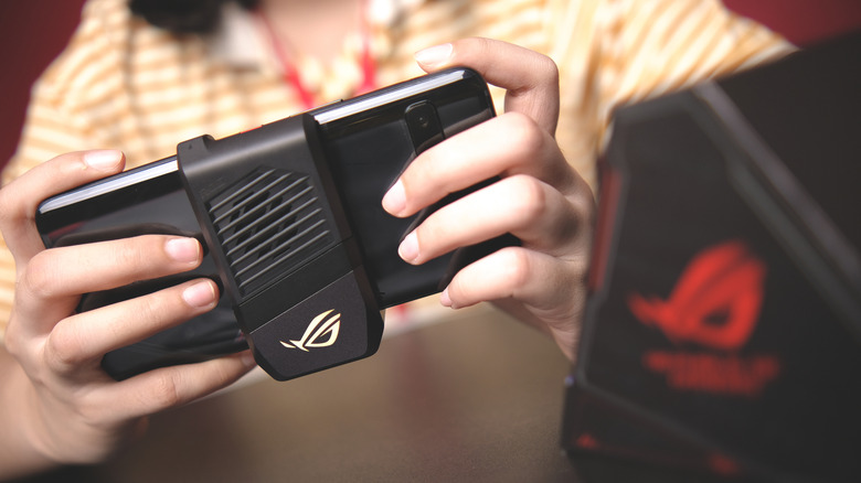 An Asus ROG Phone 3 with a controller accessory attached.