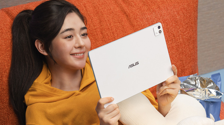 An Asus tablet held in a woman's hands.