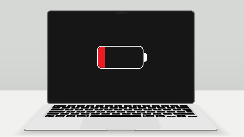 A mockup of a MacBook displaying a low battery warning on its screen