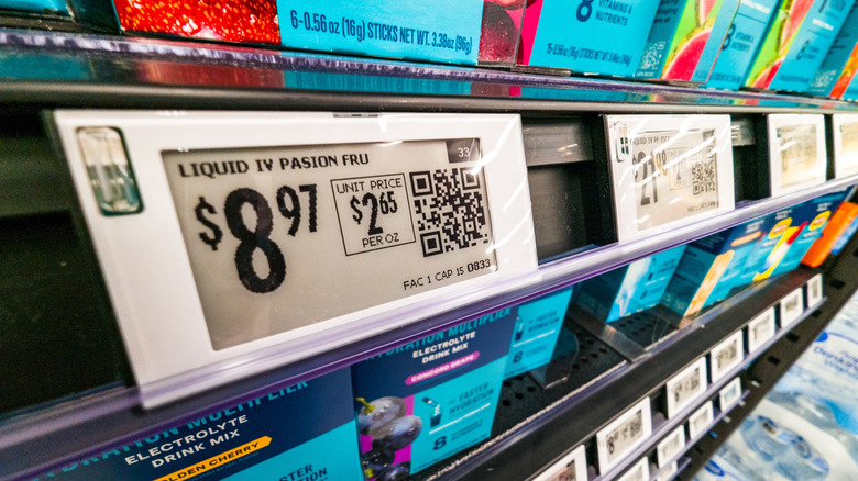 digital price tags on a store shelf showing updated prices with QR codes