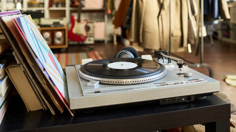 A vinyl record on a record player in a thrift store
