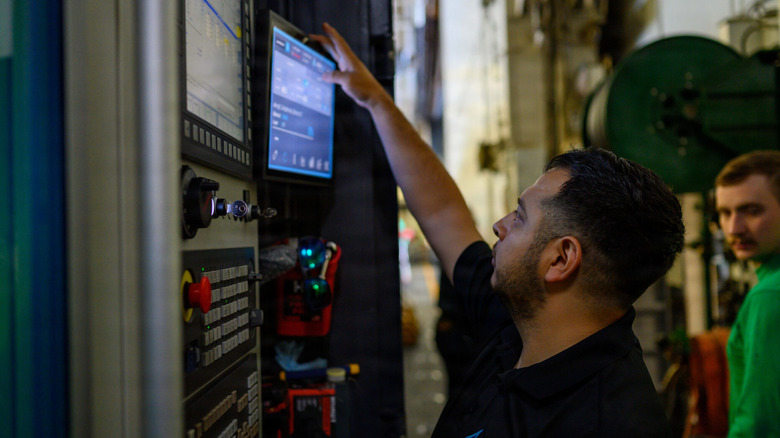 A 3D printer operator seen in the hangar bay of Nimitz-class aircraft carrier USS Theodore Roosevelt (CVN-71) in the Pacific Ocean en route to participate in Exercise Rim of the Pacific 2026, June 17, 2026
