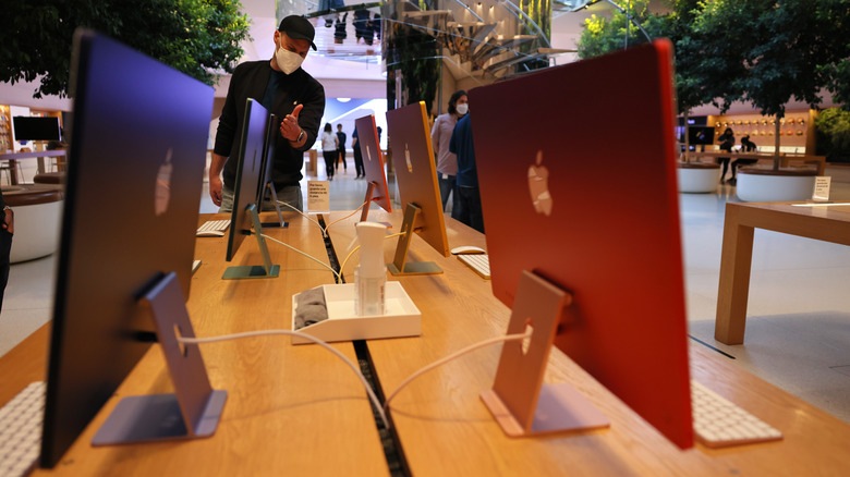 People look at iMac color computer on display