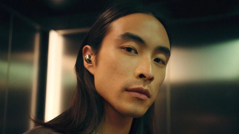 Sennheiser Momentum True Wireless 5 earbuds worn by model.