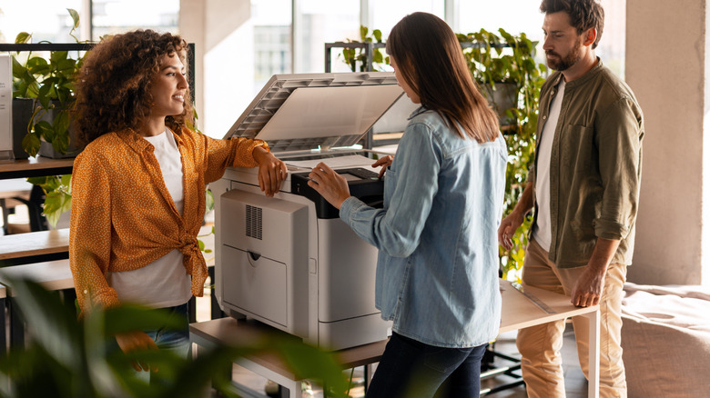 Workers around an office printer
