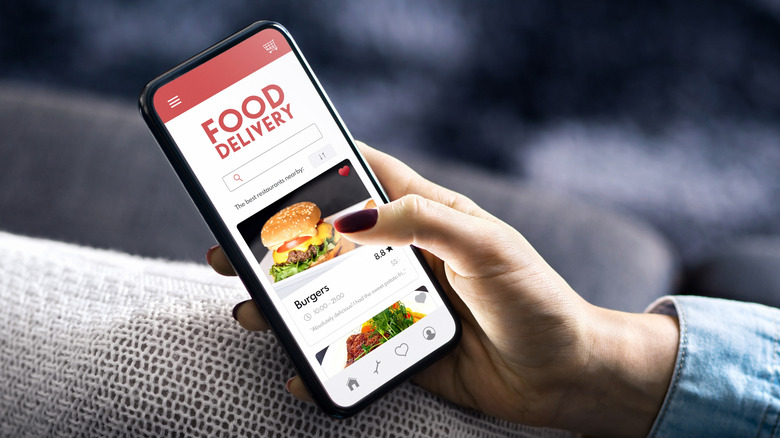 person browsing a food delivery app on a smartphone